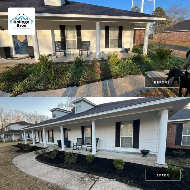 Long front porch and curved walkway with fresh black mulch beds in warm evening light