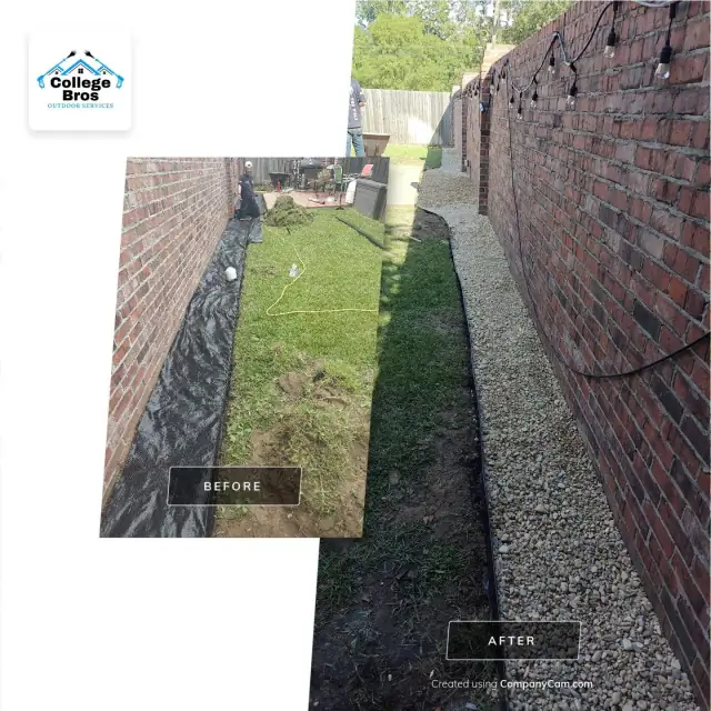 Gravel strip along a brick wall with string lights overhead