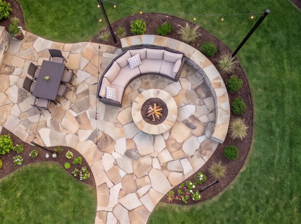 Overhead view of a hand-set flagstone patio and fire pit